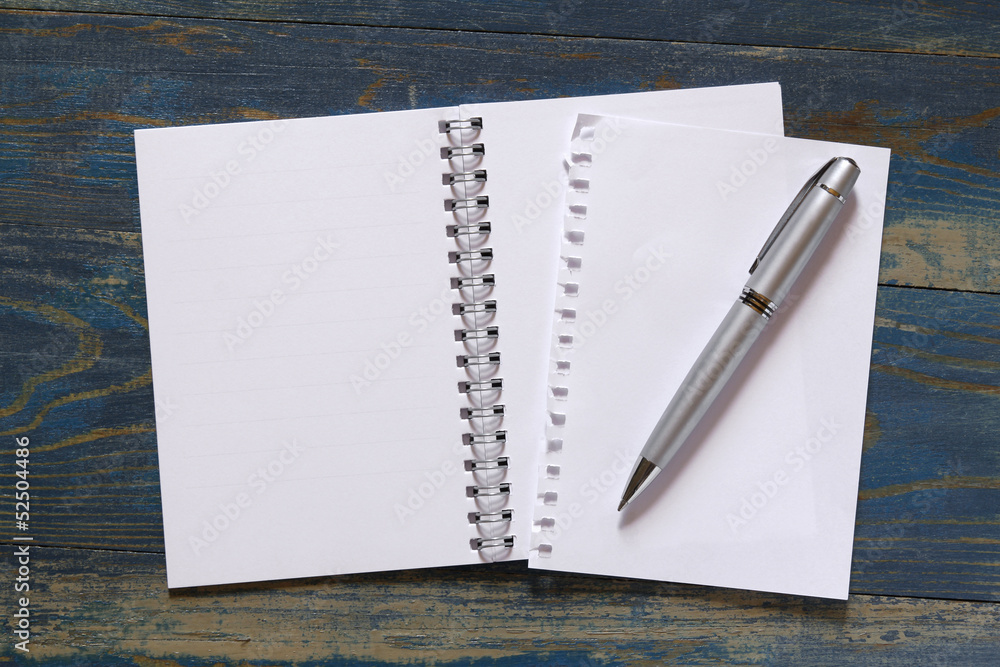 spiral notebook with pen on wooden background spiral notebook with pen on wooden background