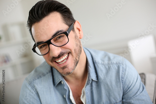 Cheerful handsome trendy guy with glasses