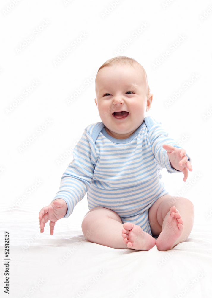 beautiful laughing happy baby boy sitting on white bed beautiful laughing happy baby boy sitting on white bed