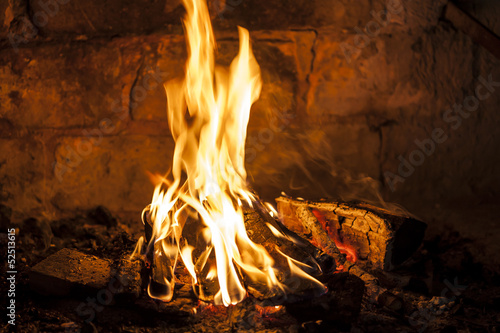 Fireplace with a blazing fire, relaxing view of the fire.