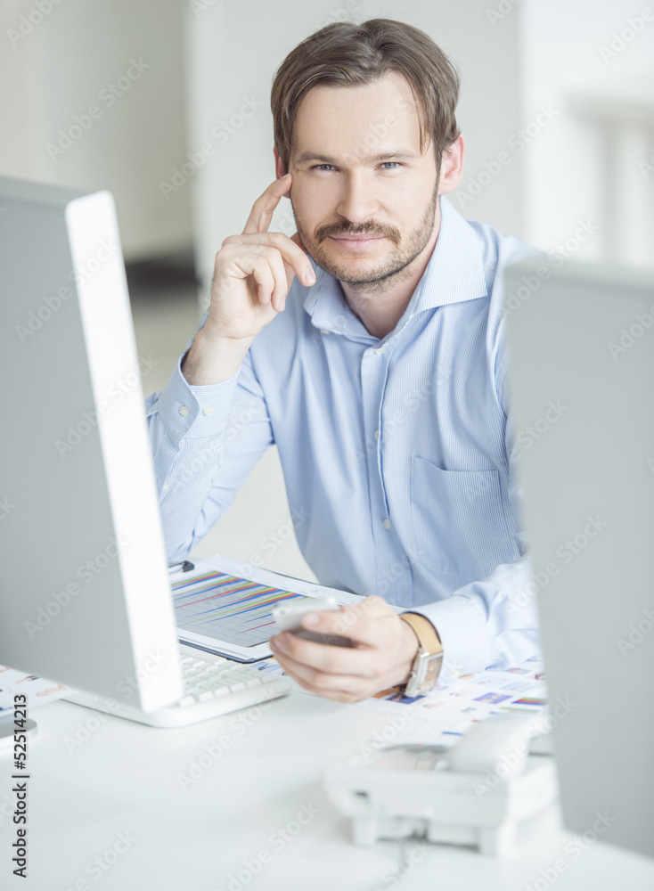 Businessman sitting in front of computer monitors