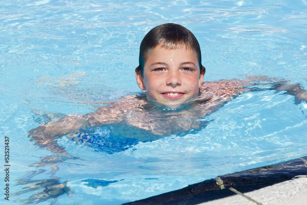 Activities on the pool. Cute boy swimming and playing in water i Activities on the pool. Cute boy swimming and playing in water i