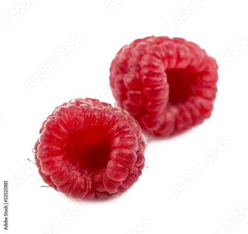 Ripe raspberry with green leaf on white background