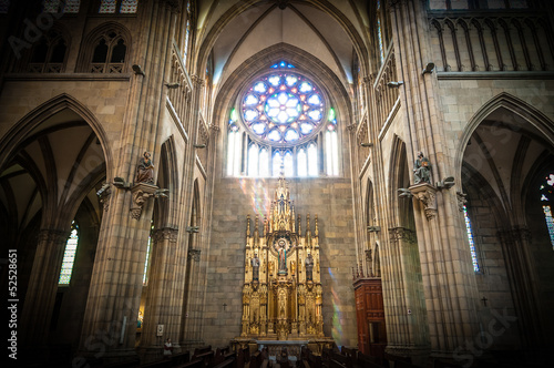 Old church interior with altar and arches.