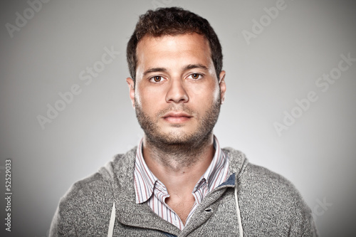 Portrait of a normal boy over grey background. photo