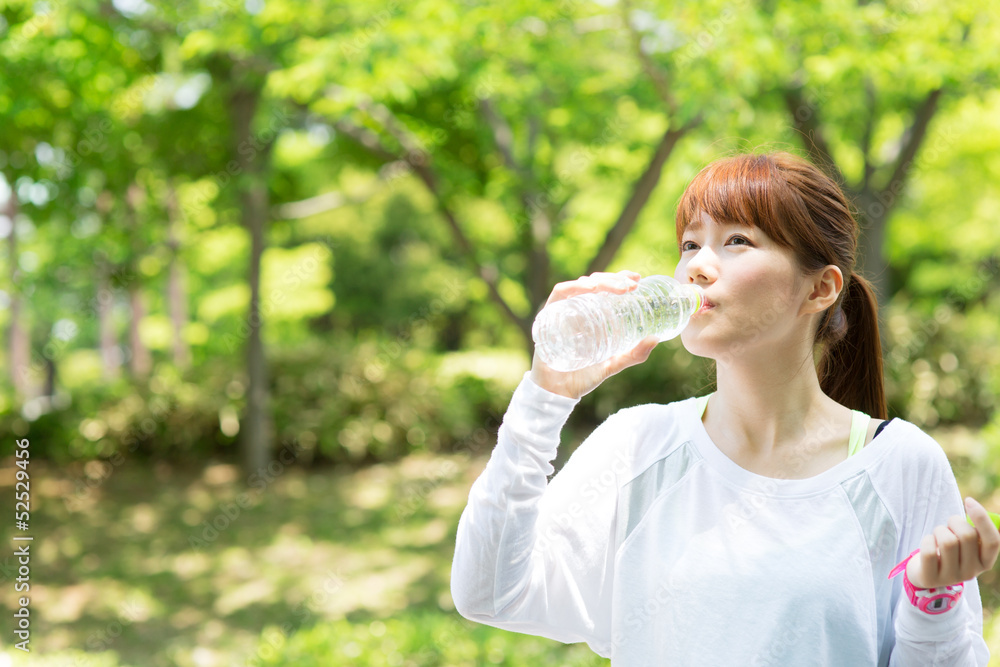 Beautiful young woman drinking water at workout Beautiful young woman drinking water at workout