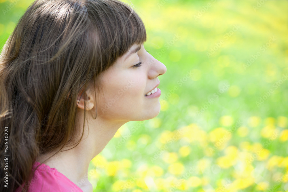 Beautiful girl enjoying the Sun on the meadow Beautiful girl enjoying the Sun on the meadow