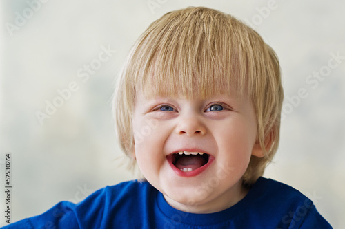 Cute little boy laughing merrily