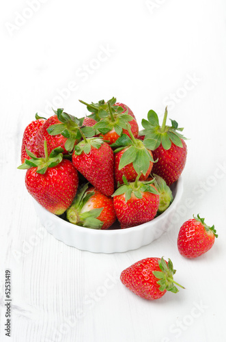 Fresh ripe strawberries in a bowl  vertical