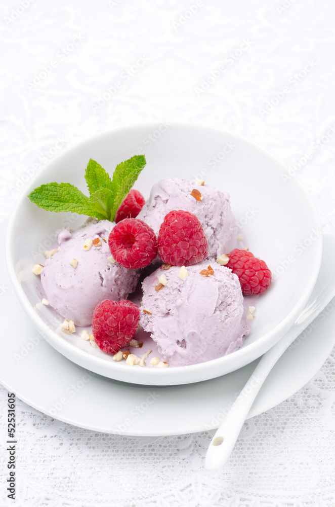 ice cream with fresh raspberries and mint in white bowl ice cream with fresh raspberries and mint in white bowl