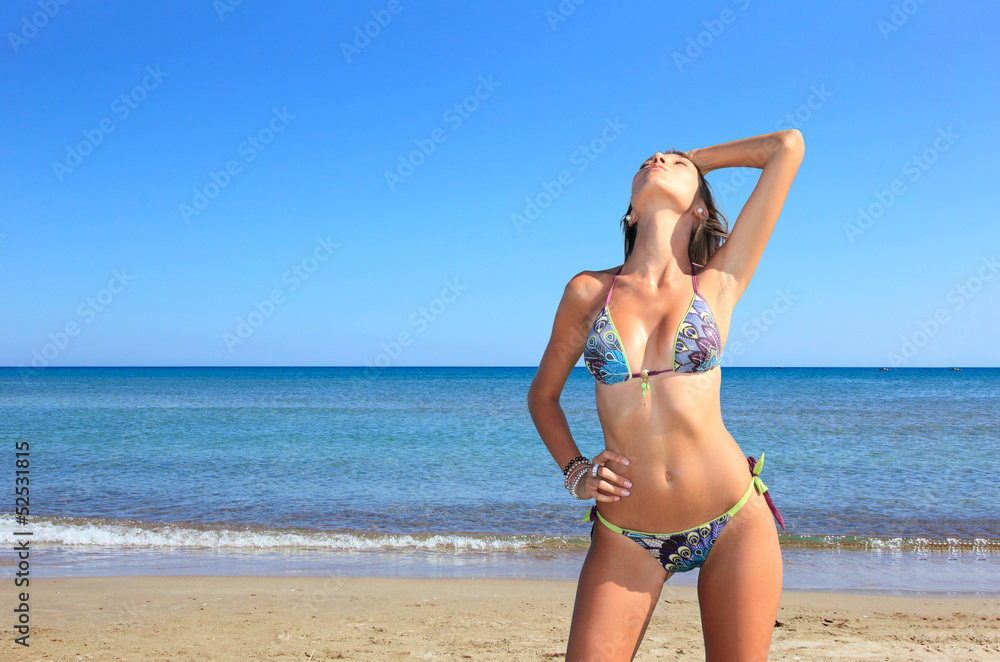 Young beautiful woman posing on the beach Young beautiful woman posing on the beach