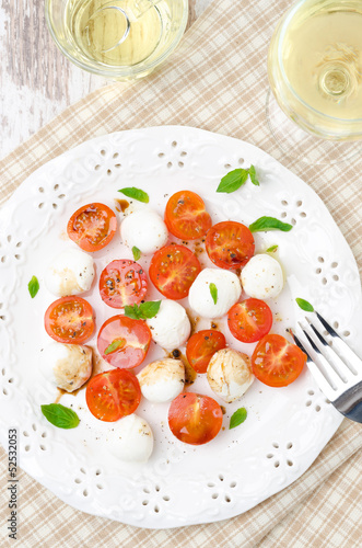 salad with mini mozzarella, cherry tomatoes, basil, top view