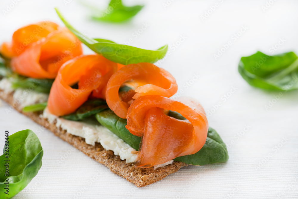 Salted salmon on crispy bread with cheese and spinach Salted salmon on crispy bread with cheese and spinach