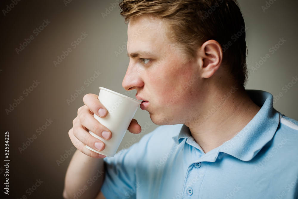 Man is drinking water from a paper cup Man is drinking water from a paper cup