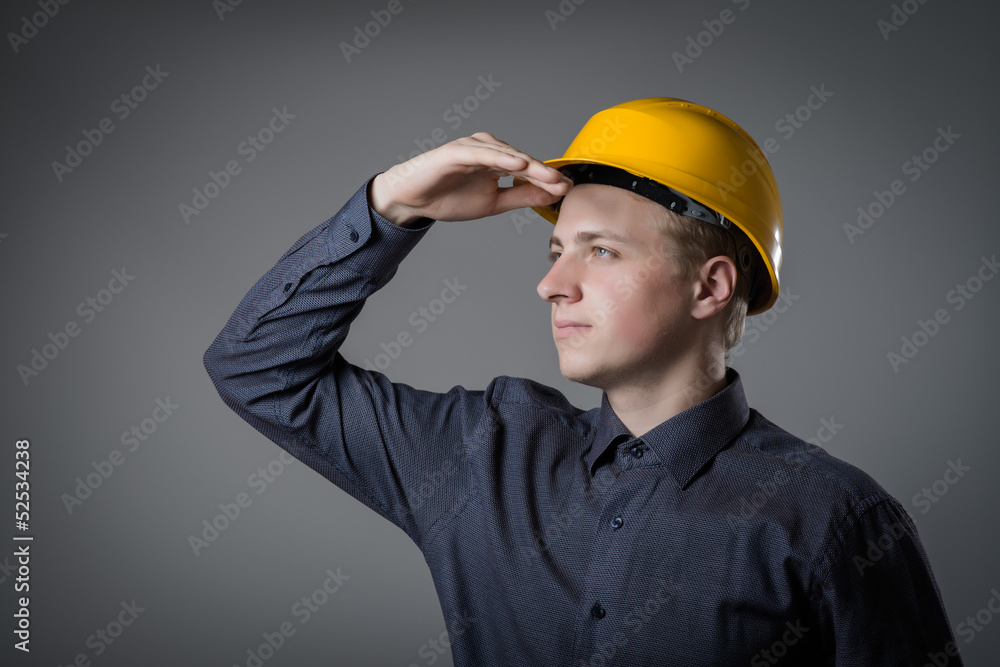 engineer in helmet looks into the distance engineer in helmet looks into the distance