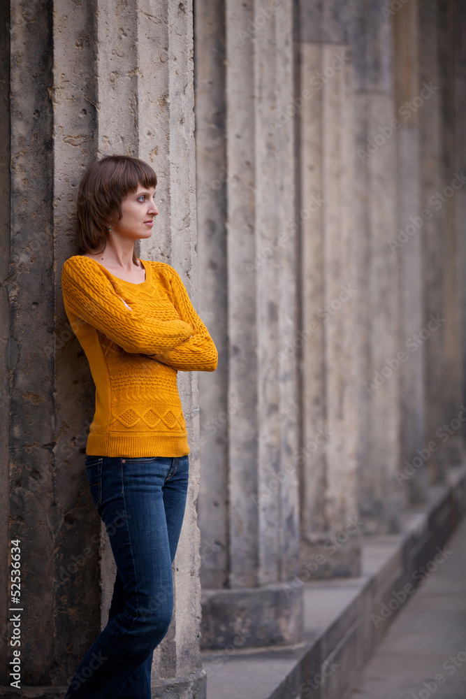 Girl staying near old columns Girl staying near old columns