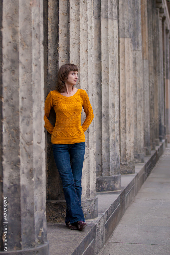 Girl is staying near old columns Girl is staying near old columns