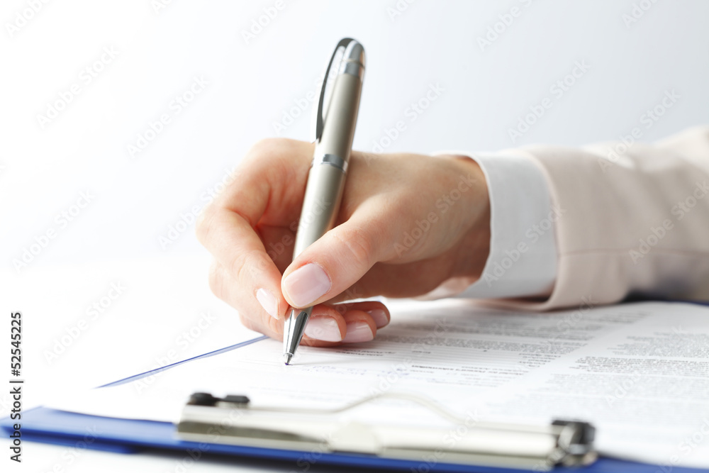 Businesswoman writing on a form Businesswoman writing on a form