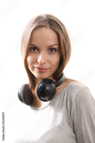 Young woman listening music with headphones, on white