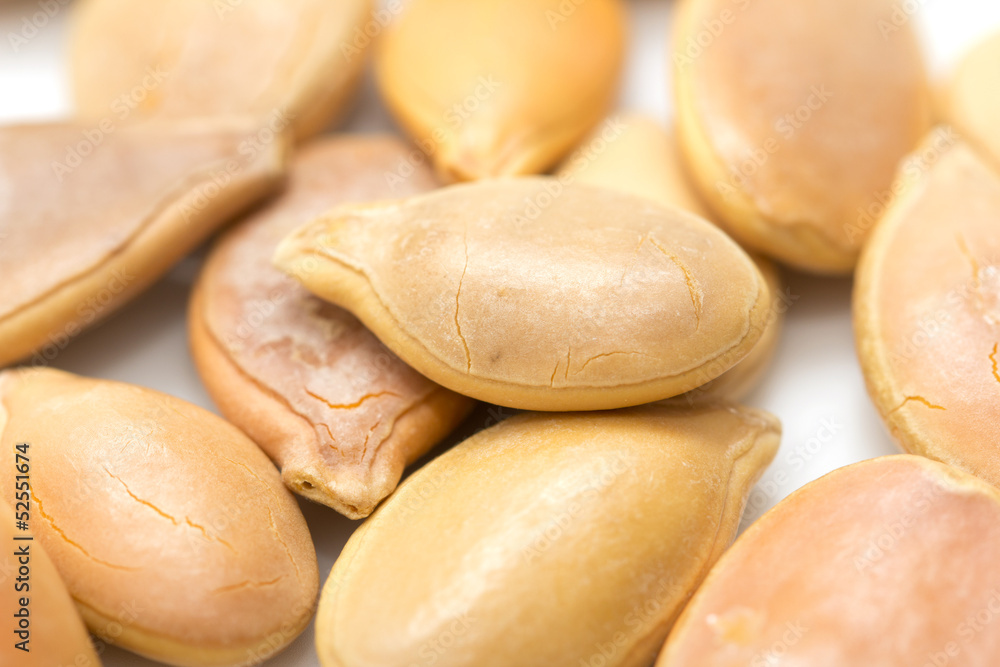 Pumpkin seeds on a white background. macro Pumpkin seeds on a white background. macro