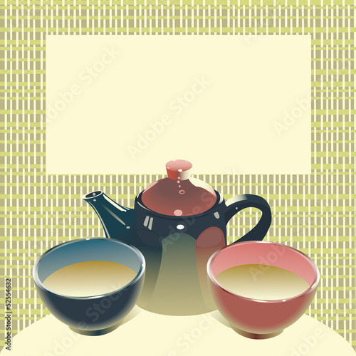 teapot with two tea bowls on mat back