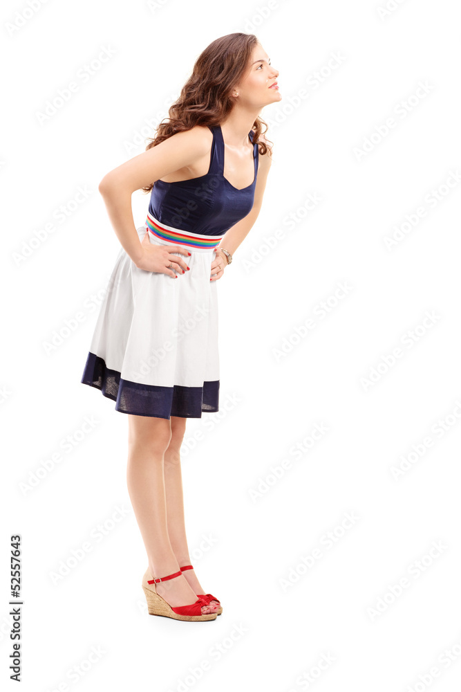 Full length portrait of a young woman in profile looking upwards Full length portrait of a young woman in profile looking upwards