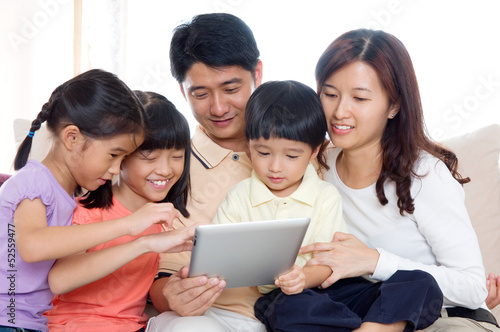 Asian family using tablet computer