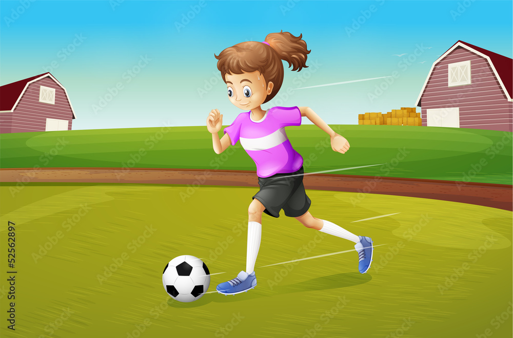 Fototapeta premium A girl playing football at the farm