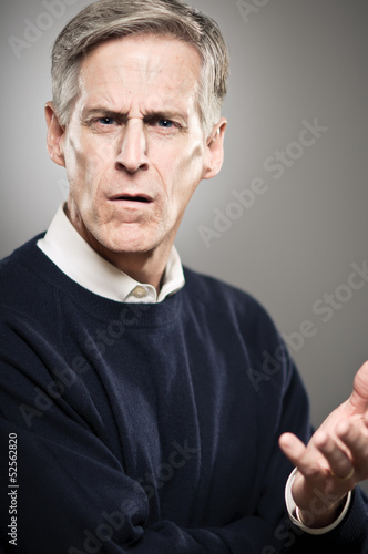 Mature Caucasian Man With Looking WIth Disapproval