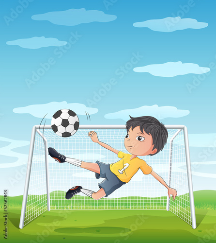 A young athlete kicking the soccer ball