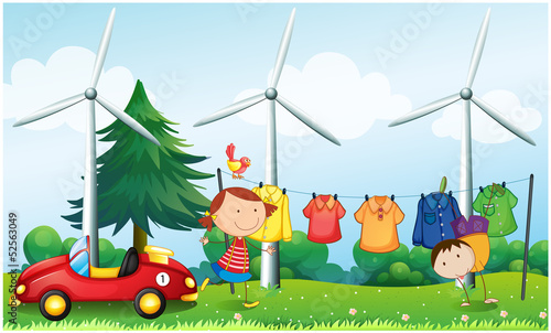Kids playing at the hill with hanging clothes