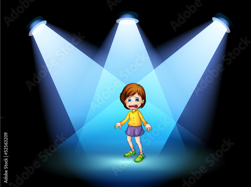 A little girl acting at the center of the stage