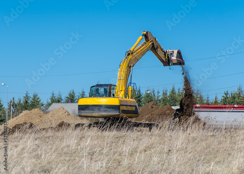 Excavator machine works at construction site