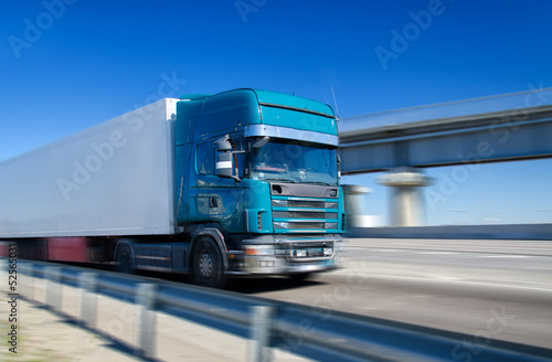 Blue truck driving on highway. Motion blur.
