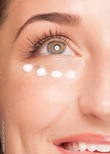 Woman applying moisturizing cream