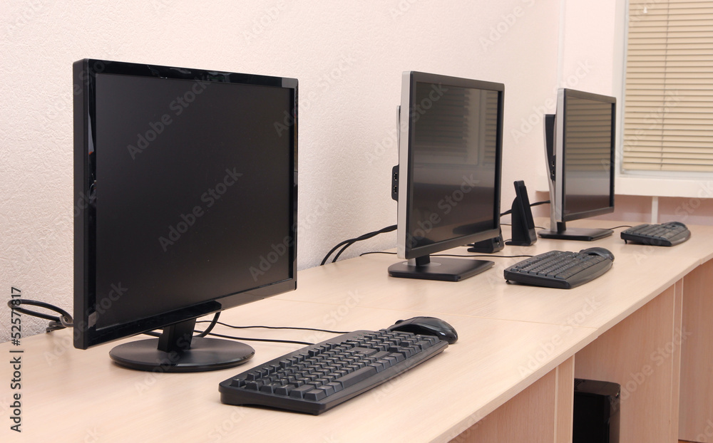 Computers on tables in room Computers on tables in room