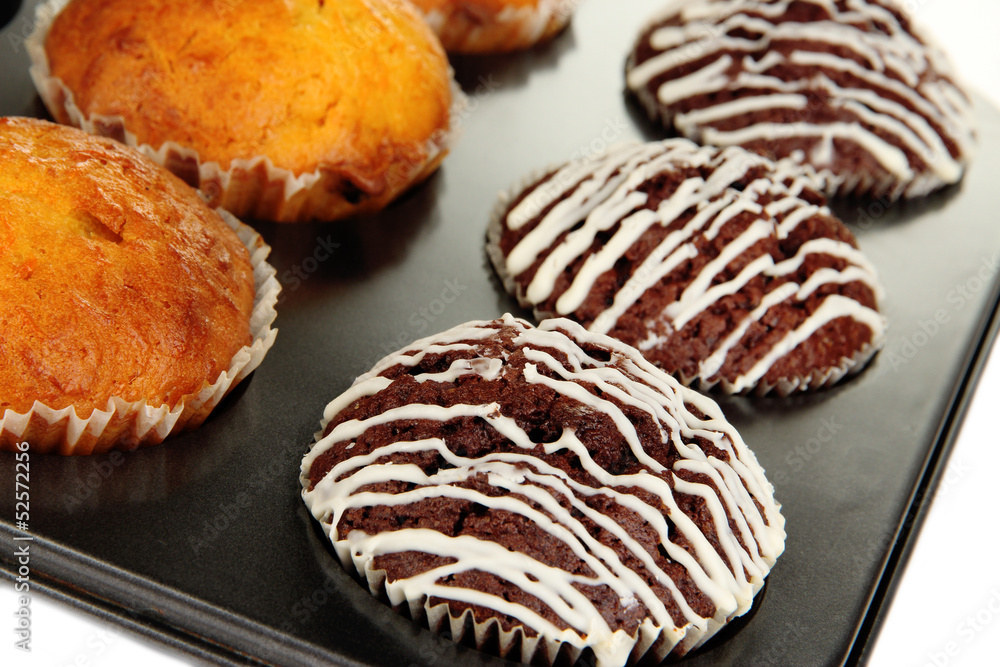 Tasty muffin cakes in baking tray close up Tasty muffin cakes in baking tray close up