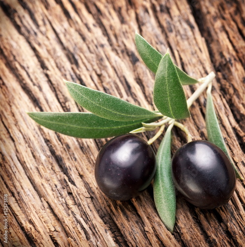 Ripe black olives with leaves.