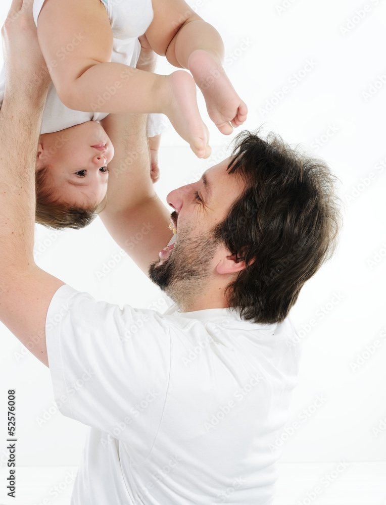 Obraz premium Happy young man holding a smiling 4-5 months old baby, isolated