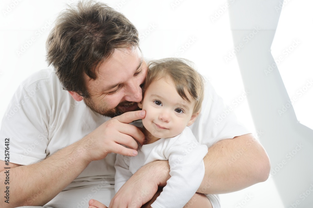 Happy young man holding a smiling 4-5 months old baby, isolated Happy young man holding a smiling 4-5 months old baby, isolated