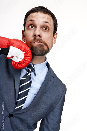 Konstfotografi Young business man struck by hand in boxing glove