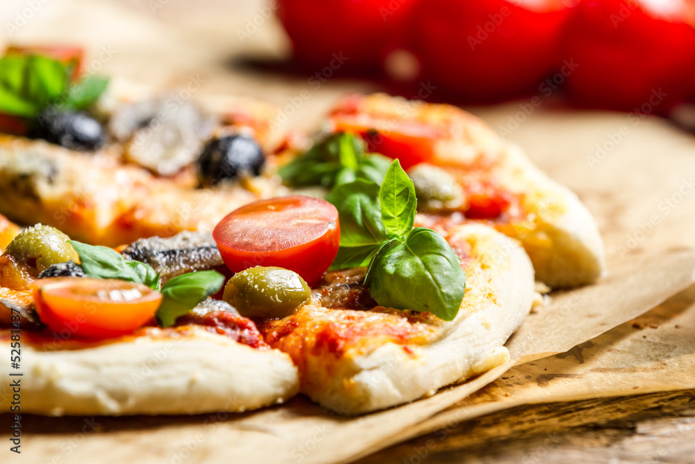 Close-up of freshly baked pizza with tomatoes and olives