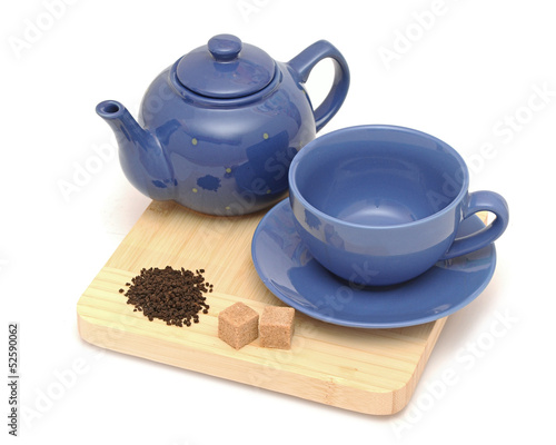 Teapot, cup and sugar on white background