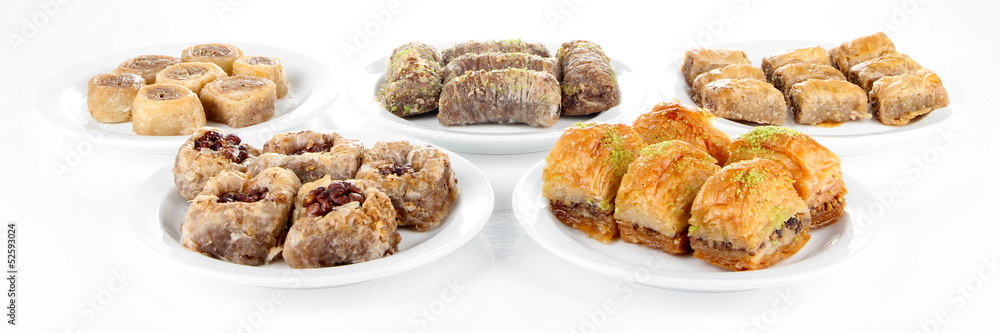 Sweet baklava on plates isolated on white Sweet baklava on plates isolated on white