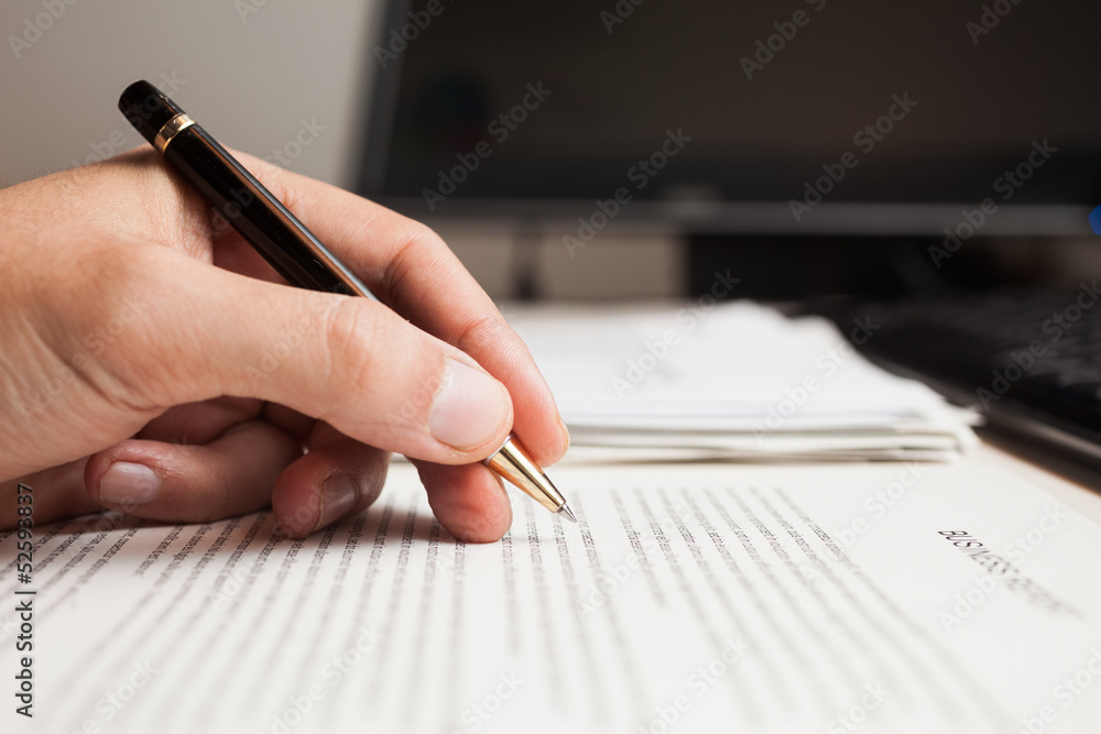 Naklejka premium Man checking text on a business document