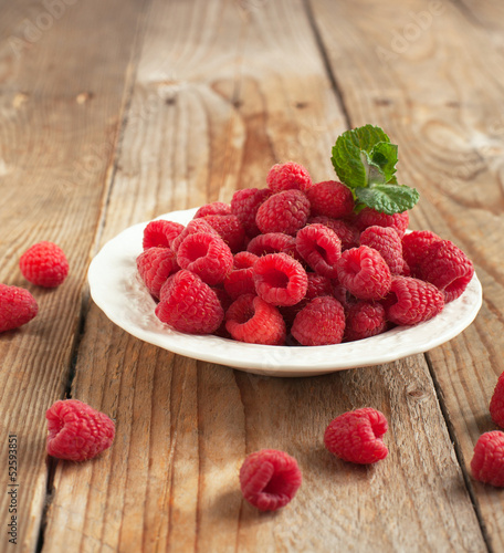 Fresh  raspberry in plate. Selective focus