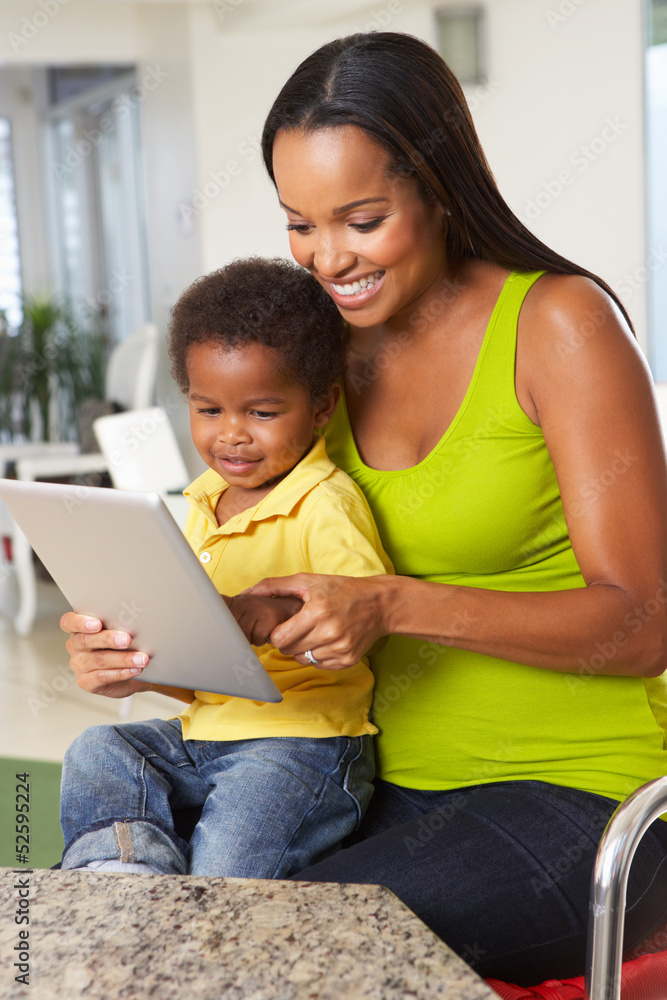 Mother And Son Using Digital Tablet In Kitchen Together Mother And Son Using Digital Tablet In Kitchen Together