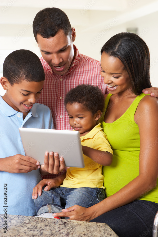 Family Using Digital Tablet In Kitchen Together Family Using Digital Tablet In Kitchen Together