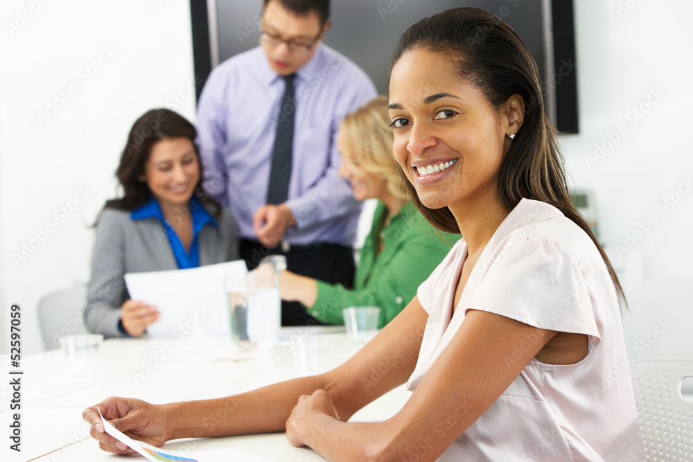 Portrait Of Businesswoman In Boardroom With Colleagues