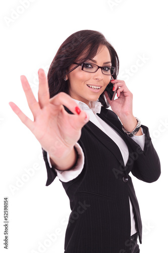 business woman on phone, ok sign